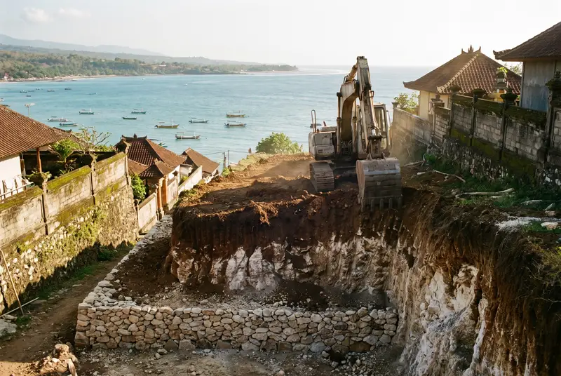 Excavator cutting a hillside building terrace overlooking Jimbaran bay Bali