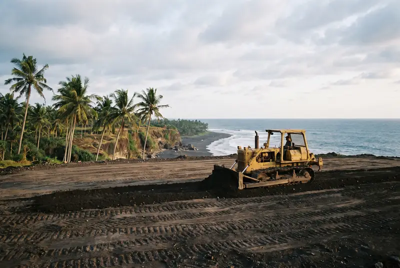 Bulldozer leveling a coastal plot with ocean view in Kedungu Tabanan Bali